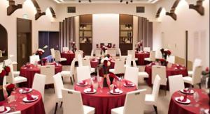 a dining room with red tables and white chairs at Daini Fuji Hotel in Nagoya