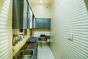 a small kitchen with a sink and a counter at Jasneet Homestay in Amritsar