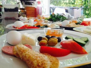 a plate of food with eggs and vegetables on a table at Hotel Nisa in Kas