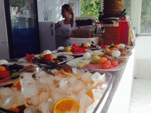 a buffet line with many plates of fruits and vegetables at Hotel Nisa in Kaş