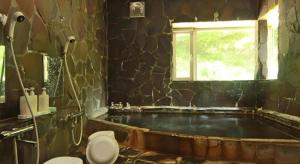 a bathroom with a tub with a toilet and a window at Yumekiko in Nasushiobara +27 photos