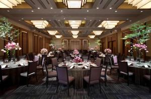 a banquet hall with tables and chairs and flowers at Nippondaira Hotel in Shizuoka