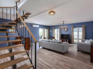 a living room with a couch and a staircase at Rustic Villa Nina Tucepi in Tučepi