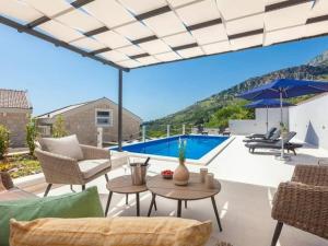 a patio with a view of a swimming pool at Rustic Villa Nina Tucepi in Tučepi