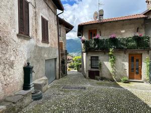 an alley in an old town with buildings at Dina’s Flower House in Lierna
