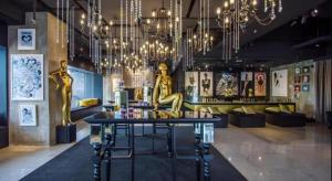 a room with a table and chandeliers in a store at The Hulo Hotel & Gallery in Kuala Lumpur
