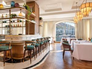 a restaurant with a bar with tables and chairs at Cape Grace, A Fairmont Managed Hotel in Cape Town