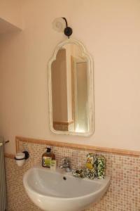 a bathroom with a sink and a mirror at Affittacamere Gir di Mura in Montecatini Terme
