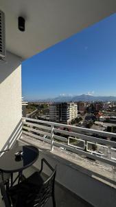 a balcony with a table and a view of a city at ILLYRIAN HOLDING Apart Hotel in Shkodër +63 photos
