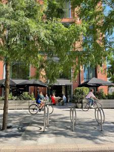 a group of people riding bikes down a street at TRIBE London Canary Wharf in London +102 photos