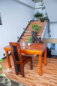 a wooden table and chairs in a room with stairs at Apartment Room - Mathara in Matara +9 photos
