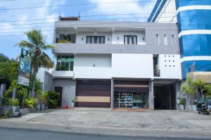 a white building with a garage in front of it at Apartment Room - Mathara in Matara