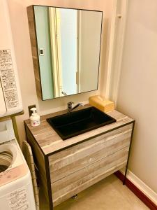 a bathroom sink with a large mirror above it at Fuji AK Vacation Rental in Fujiyoshida