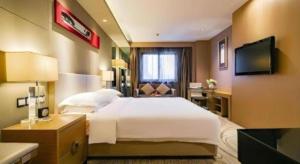 a hotel room with a large bed and a television at Ramada by Wyndham Xi'an Bell Tower in Xi'an +37 photos