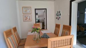 a dining room with a table and chairs with flowers on it at Ferienwohnung Havelnixe in Bahnitz +18 photos
