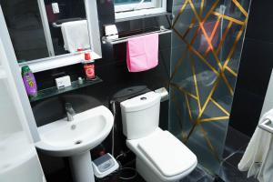 a bathroom with a white toilet and a sink at One Bedroom Condominium at Kandi Tower 2 in Angeles +10 photos