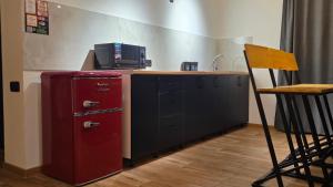 a kitchen with a red refrigerator and a microwave at Chill out Zone , villa with 4 bedrooms, whole apartment, апартамент целиком in Dilijan