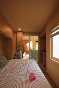 a bedroom with a large bed with a pink box on it at Amya home Hoi An in Hoi An