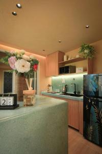 a kitchen with a counter with flowers on it at Amya home Hoi An in Hoi An +9 photos