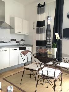 a kitchen with a dining room table and chairs at Ana Apartment in Pula