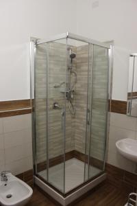 a bathroom with a shower stall and a toilet at Dei Mille in Sassari