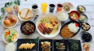 a table filled with plates of food and drinks at Kyoto Plaza Hotel Kyoto Station South in Kyoto