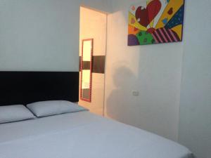 Postel nebo postele na pokoji v ubytování Hotel Arcoiris Girardot
