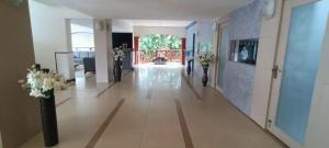 a hallway of a building with vases of flowers at Sun City Resort in Calangute