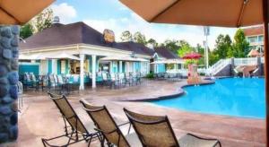 a group of chairs sitting next to a swimming pool at Disney's Saratoga Springs Resort & Spa in Orlando