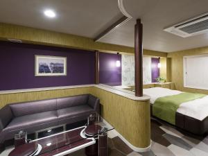 a hotel room with a bed and a couch at Hotel Rose (Adult Only) in Gifu +22 photos