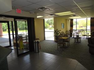 a lobby with tables and chairs and a dining area at Best Inn Formerly Known as M Star Hotel in Chickasaw