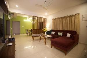 a living room with a couch and a table at 4BHK Villa in Anjuna with private Jacuzzi and pool, 1KM from beach in Anjuna