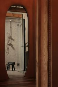 a bathroom with a shower with a glass door at Castelul de Lut - Eco Boutique Guesthouse in Porumbacu de Sus +148 photos