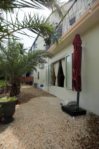 a red umbrella sitting outside of a building at Amya Hoi An Cam Chau in Hoi An