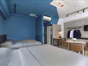a bedroom with a bed and a table and chairs at ibis budget Phnom Penh Riverside in Phnom Penh +25 photos