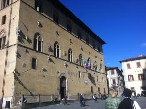 a group of people walking around a large building at Residenza Gatteschi in Pistoia