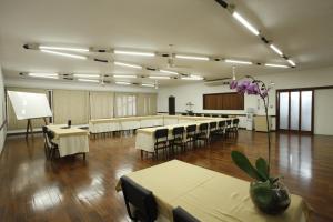 a large room with tables and chairs and a podium at Hotel Match Point in São Carlos
