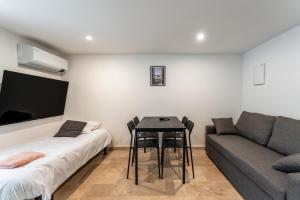 a living room with a table and a couch at Canto Cigalo Duplex 12 in Robion en Luberon