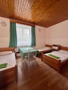 a room with two beds and a table in it at Ubytování Přimda in Přimda