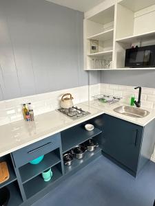 a kitchen with a sink and a counter top at Sundays River Adventures Cottages in Gqeberha