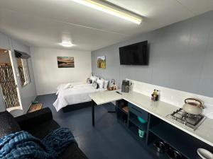 a bedroom with a bed and a desk in a room at Sundays River Adventures Tiny Homes in Gqeberha