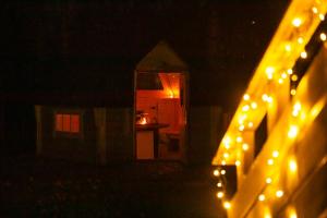 a dark room with a kitchen and a table with lights at Arctic Aurora Villa With A Hut - Northern Lights and Adventures in the Hometown of Santa Claus, Rovaniemi in Rovaniemi