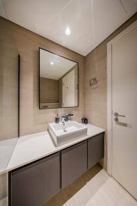 a bathroom with a sink and a mirror at 1BR Luxury Suite at Misk - Aljada Center - 2WC in Sharjah
