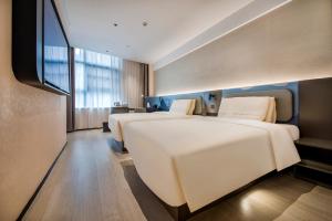 Ένα ή περισσότερα κρεβάτια σε δωμάτιο στο Atour Light Hotel Guangzhou Haizhu Nanxi Subway Station +78 φωτογραφίες