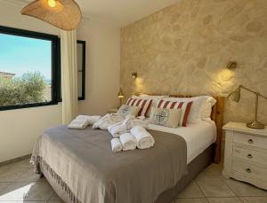 a bedroom with a bed with towels on it at Residence SardegnaSummer Li Cuppulati in San Teodoro