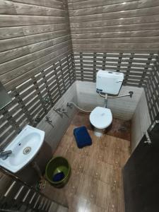 a bathroom with a toilet and a sink at Hotel shivalay in Dwarka