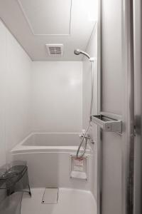 a white refrigerator in a kitchen with a sink at Silk Court 201 in Chitose