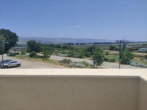 a view of a parking lot with a car at River and Mountains in HaGoshrim