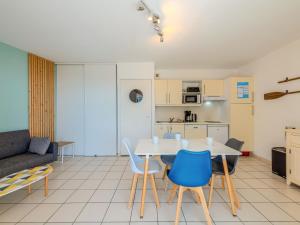 a kitchen and a living room with a table and chairs at D de Bertheaume N214 2P5 in Plougonvelin