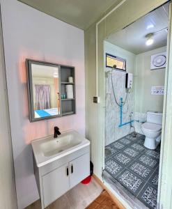a bathroom with a sink and a shower with a toilet at Naroth Beach Bungalow in Koh Rong Island